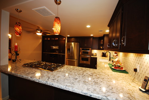 Mocha Stained Maple Cabinets with Cambria Bellingham Countertop, Diagonal Set Up Marble Backsplash and Glass Kitchen Pendant